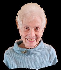 Smiling elderly woman wearing a blue sweater.