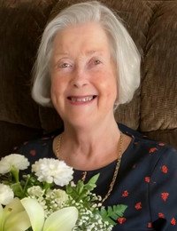 Elderly woman smiling with a flower bouquet