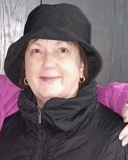 Person wearing a hooded jacket, smiling.