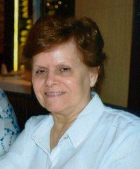 Smiling person in a white shirt indoors.