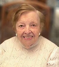 Smiling elderly woman in white sweater