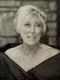Smiling woman in elegant dress, black-and-white photo
