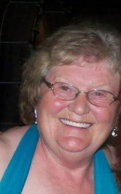 Smiling woman in glasses and blue dress