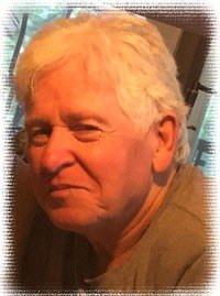 Smiling older adult with white hair, indoors.