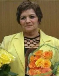 Person holding bouquet of yellow and orange flowers