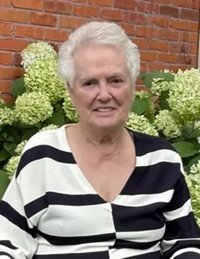 Elderly woman smiling in garden setting