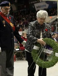 Veterans placing a wreath at a memorial event.