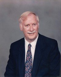 Smiling man in suit with patterned tie