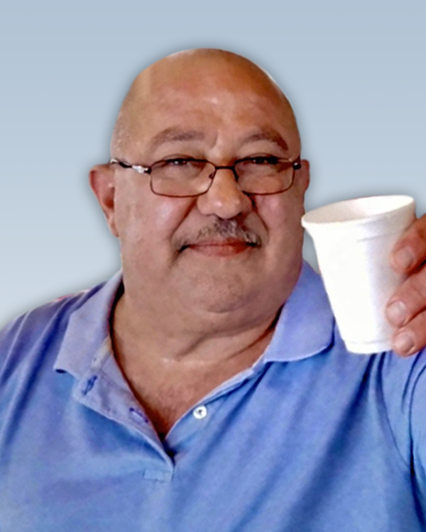 Man holding a white disposable cup.
