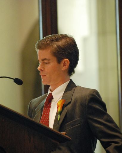 Man giving a speech at a podium.