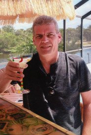 Man enjoying a cocktail outdoors