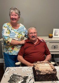 Smiling couple celebrating with a birthday cake