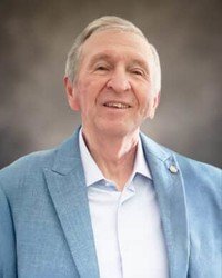 Smiling person in blue blazer portrait.