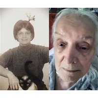 Older and younger woman side-by-side, holding cat.