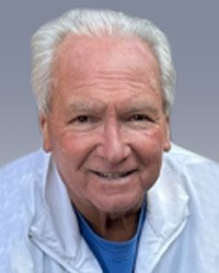 Smiling elderly man in white jacket