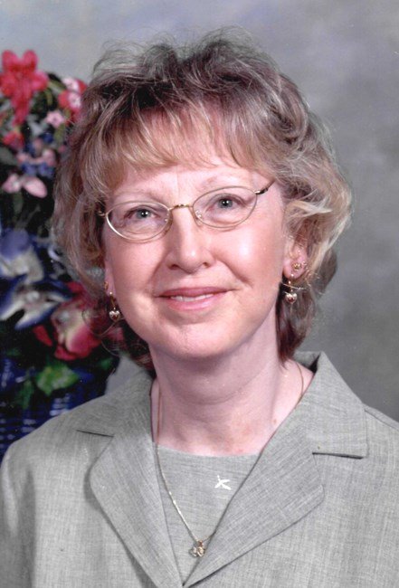 Smiling woman with glasses and curly hair