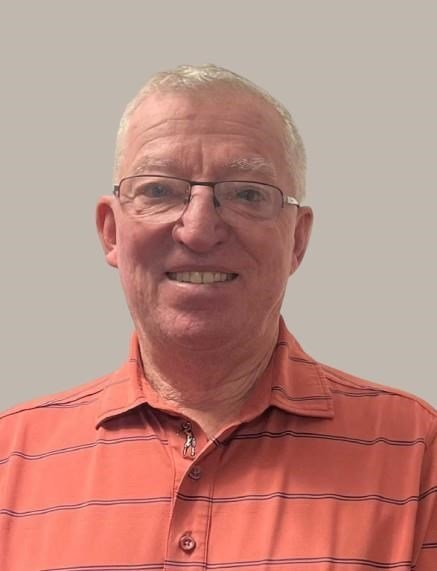 Smiling man in striped polo shirt.