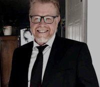 Smiling man in suit and glasses