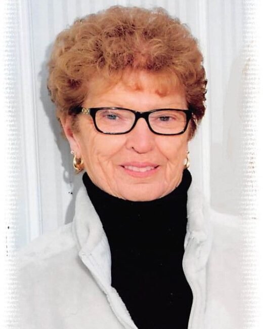 Smiling elderly woman with glasses and short hair