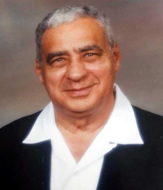 RODRIGUES, Noel Emanuel Rodrigues Smiling person in formal attire, grayish hair
