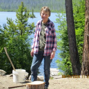 Person standing by lake in outdoor setting