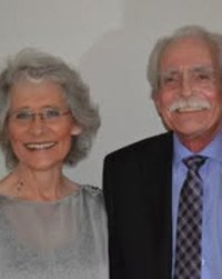 Smiling elderly couple dressed formally