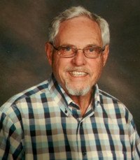 Smiling man in plaid shirt and glasses