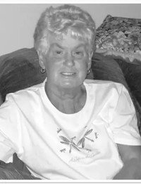 Smiling person sitting on a couch at home.