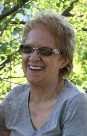 Smiling person wearing sunglasses outdoors