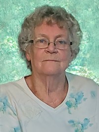 Elderly woman with glasses and curly hair portrait.
