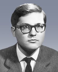 Black and white photo of a man with glasses.