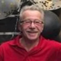 Smiling person in red shirt indoors
