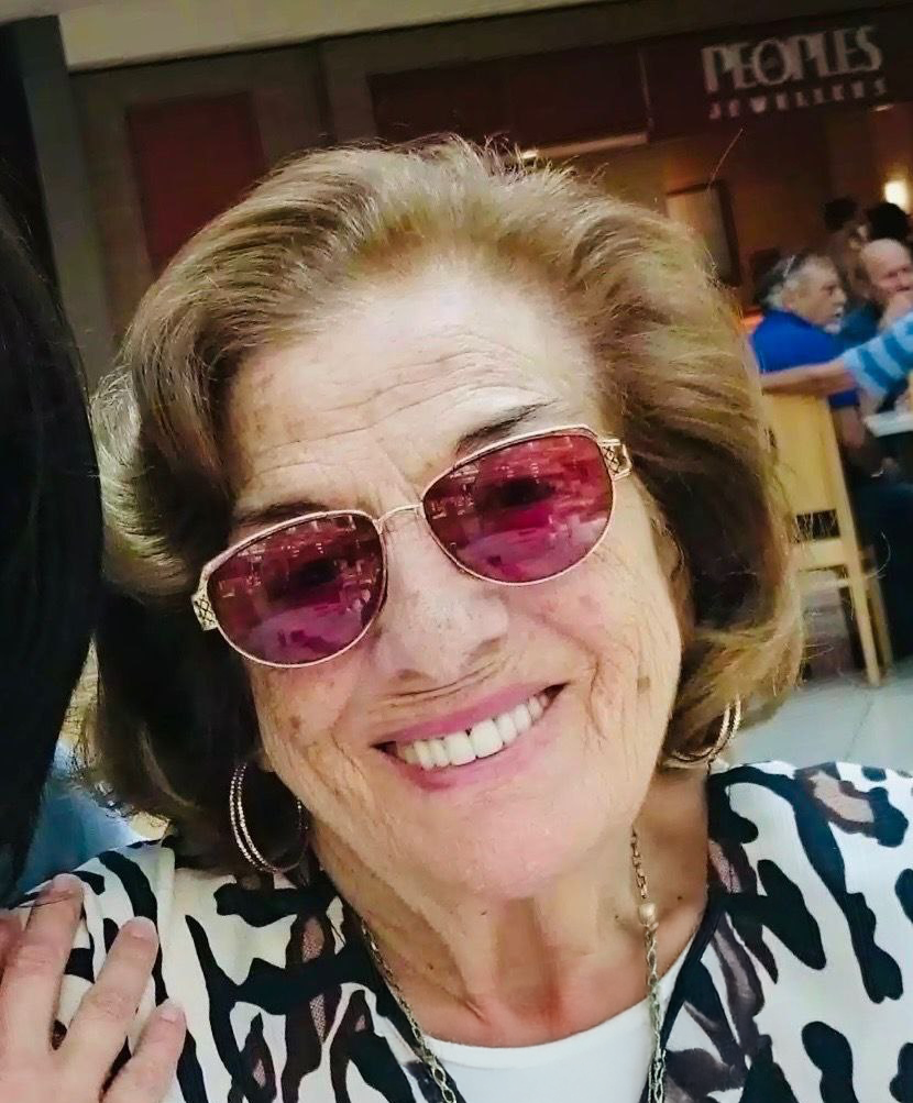 Smiling woman wearing sunglasses indoors.