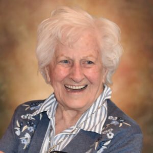 Elderly woman smiling in floral sweater