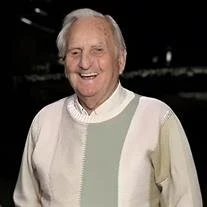 Smiling elderly man in a patterned sweater