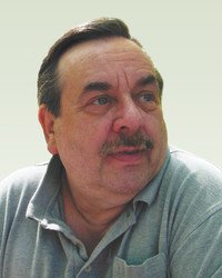 Man with mustache and gray shirt looking aside.
