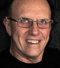 Smiling person with glasses in dark sweater