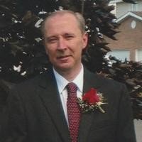 Man in suit with red flower corsage