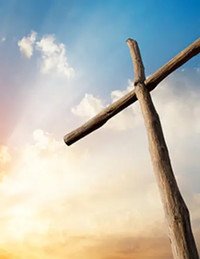 Wooden cross against sky with clouds and sun
