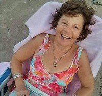 Smiling woman relaxing on the beach chair