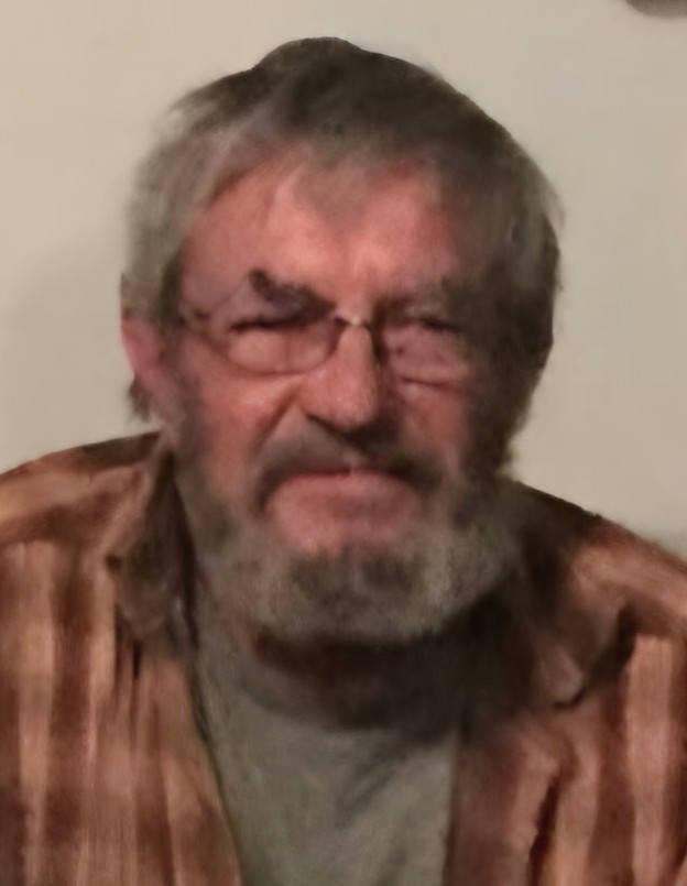 Elderly man with glasses and beard.