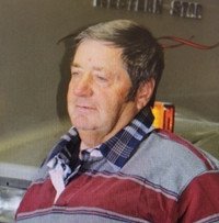 Elderly man in plaid shirt outdoors