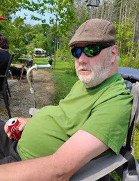 Man relaxing outdoors with a soda