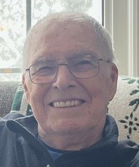 Smiling elderly man with glasses indoors