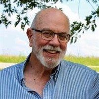 Smiling man outdoors in striped shirt
