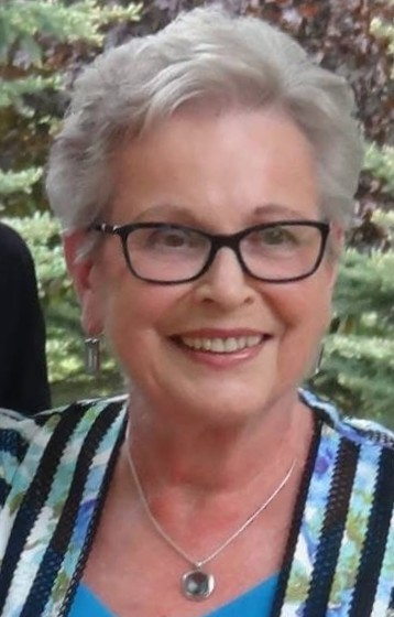 Smiling woman with glasses outdoors
