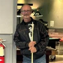 Man holding pool cue in a billiards room