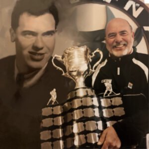 Two men with a large sports trophy