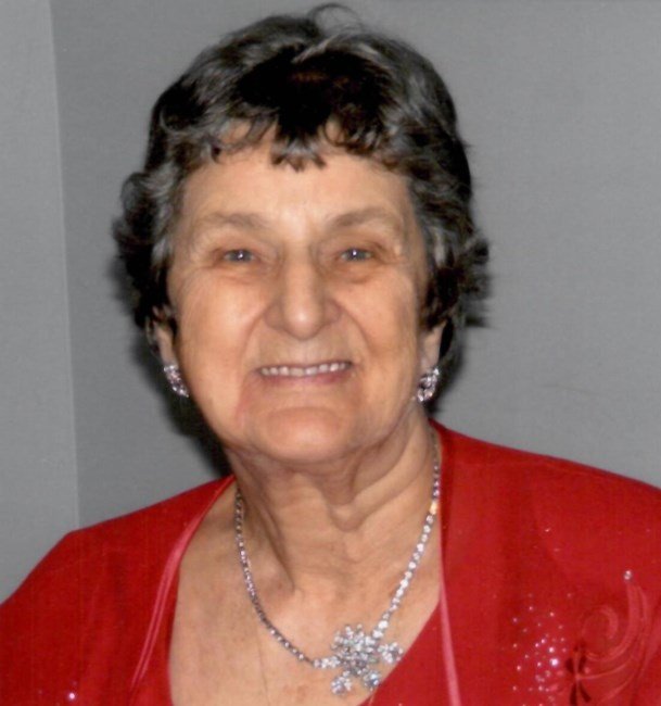 MALENFANT, Rollande Marie Malenfant Elderly woman smiling in red dress with necklace.