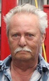 Elderly man with white hair and mustache.